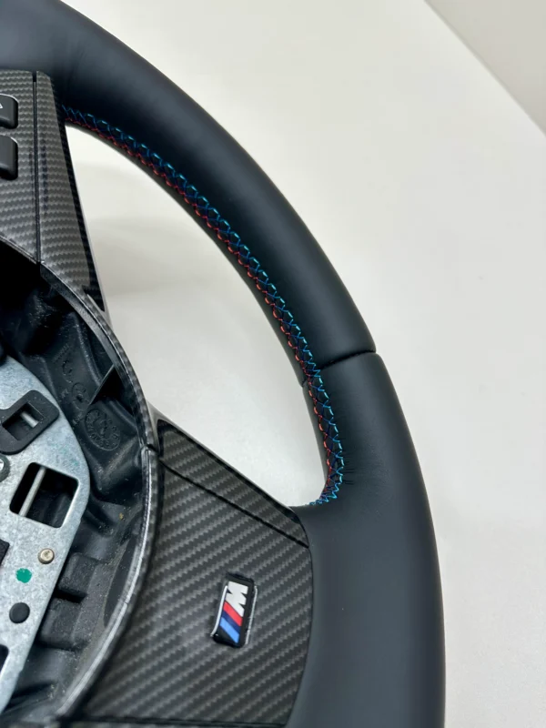 bmw-e60-e63-e64-m-sport-steering-wheel-carbon-04 bmw e60 e63 e64 m sport steering wheel m tricolor stitching carbon trim bottom right stitches