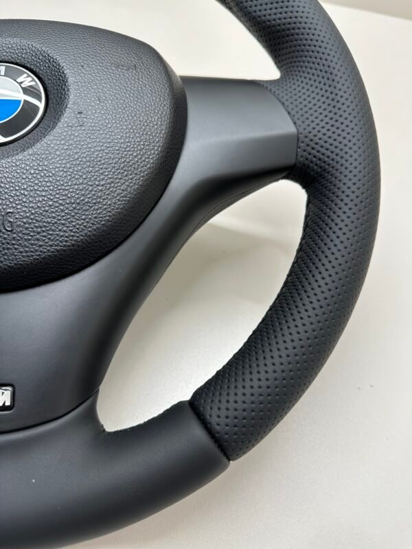 Bottom right view of a buttonless BMW M Sport steering wheel for E90 E92 E87 E82 with black stitches