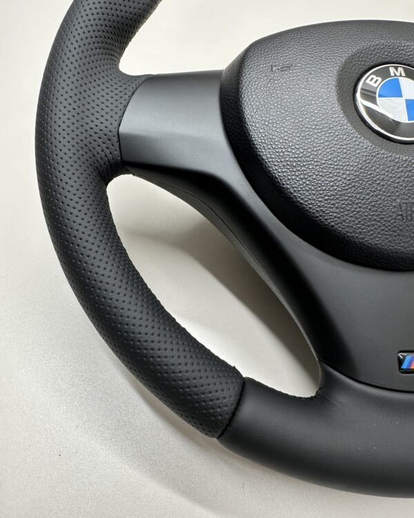bottom left view of a buttonless BMW M Sport steering wheel for E90 E92 E87 E82 with black stitches