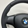 Top left view of a buttonless BMW M Sport steering wheel for E90 E92 E87 E82 with black stitches