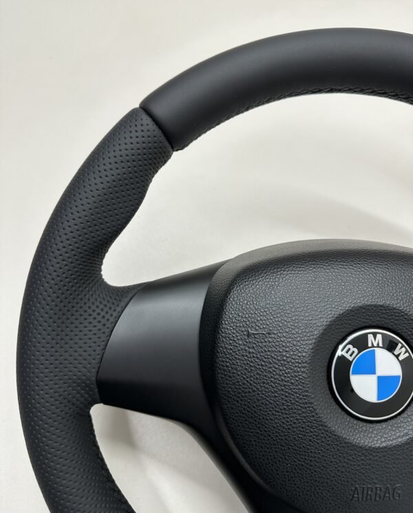 Top left view of a buttonless BMW M Sport steering wheel for E90 E92 E87 E82 with black stitches