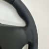 Back side view of a buttonless BMW M Sport steering wheel for E90 E92 E87 E82 with black stitches upclose