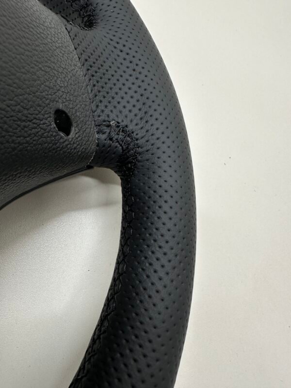 back side view of a buttonless BMW M Sport steering wheel for E90 E92 E87 E82 with black stitches