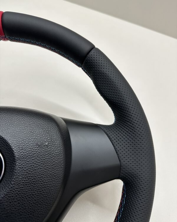 top right view of buttonless BMW M Sport steering wheel for E90 E92 E87 E82 with m stitching and red stripe at top