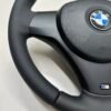 left bottom view of buttonless BMW M Sport steering wheel for E90 E92 E87 E82 with m stitching and red stripe at top