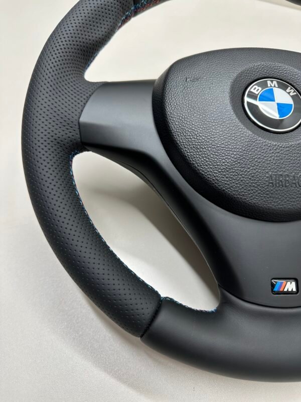 left bottom view of buttonless BMW M Sport steering wheel for E90 E92 E87 E82 with m stitching and red stripe at top