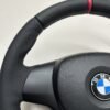 top left view of buttonless BMW M Sport steering wheel for E90 E92 E87 E82 with m stitching and red stripe at top