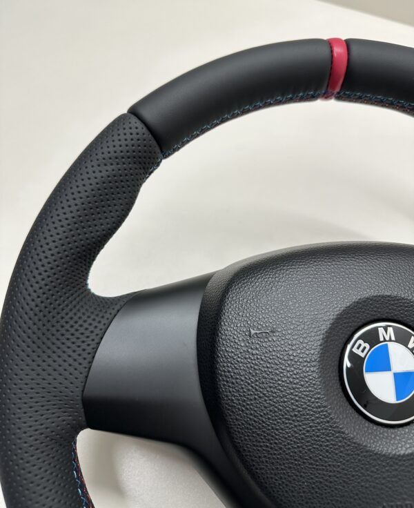 top left view of buttonless BMW M Sport steering wheel for E90 E92 E87 E82 with m stitching and red stripe at top