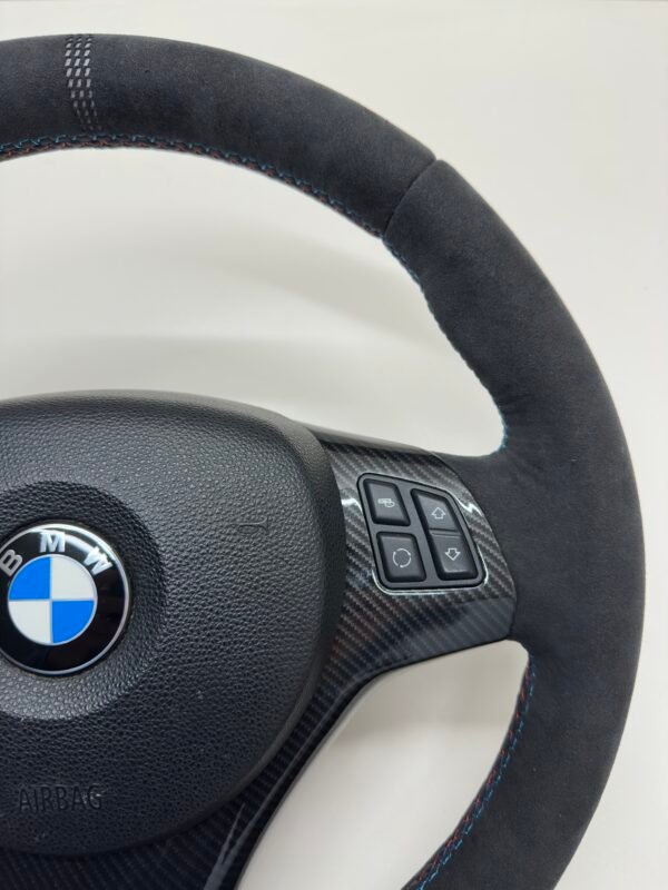 top right view of bmw e90 e92 m3 alcantara cs edition steering wheel with carbon trim buttons and airbag